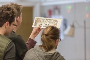 Jarad Greene ('17), Kane Lynch ('16), and Sandi B ('17) looking at Liniers' originals.