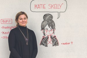 Katie Skelly next to her name board, drawn by Luke Howard. 