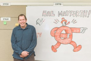 Hal Mayforth at the name board drawn by Luke Howard.