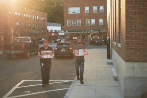 Luke and Dave bring the traditional pizza boxes in the glowing evening sun.