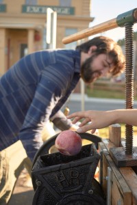 XX tossing in apples for XX to crush in the cider press.