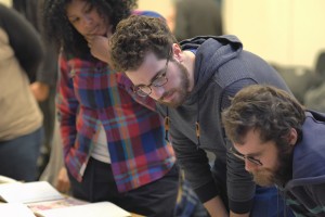 Robyn Smith ('17), Jarad Greene ('17), and Moss Bastille ('17) study Jeremy's work closely